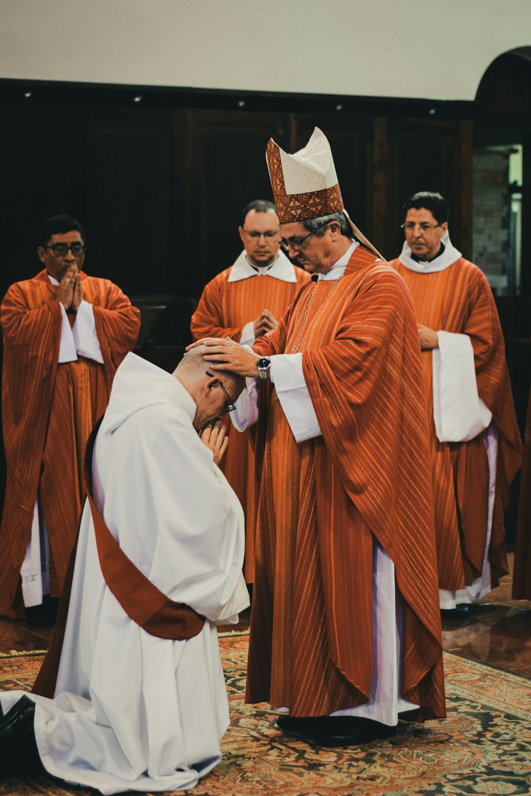 priest in brown and white robe priest in brown and white robe