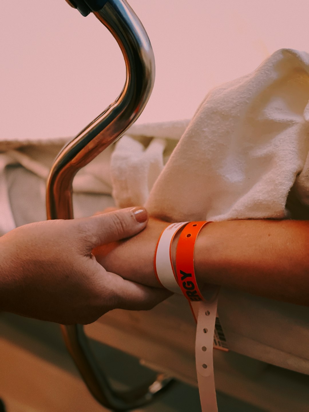 person wearing orange and white silicone band person wearing orange and white silicone band